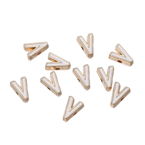 Close-up of 10mm golden alloy letter V beads with white enamel for DIY jewelry making