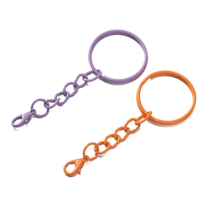 Macro shot of purple and orange painted metal lobster clasps and keyrings for DIY crafts