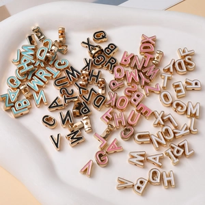 Macro shot of 10mm alloy enamel alphabet beads in various colors for DIY jewelry