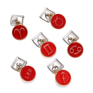 Detailed view of red enamel zodiac charm links in gold and silver stainless steel
