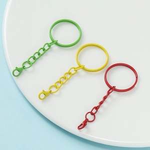 Close-up of colorful painted metal keychains with lobster clasps and chains