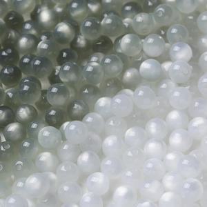Detailed view of color-changing resin beads with cat-eye effect for DIY jewelry