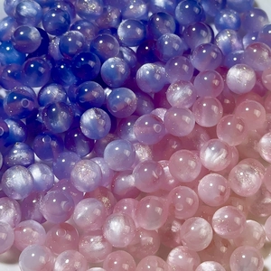 Macro shot of 8-12mm mermaid resin round beads with colorful gradient pearlescent finish
