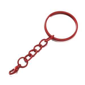 Detail of red painted metal lobster clasp and keychain ring with smooth glossy finish
