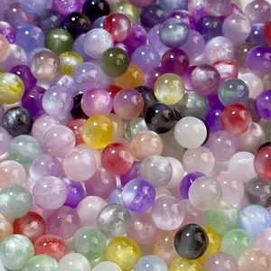 Macro shot of 8/12mm iridescent mermaid resin beads for DIY jewelry making and crafts