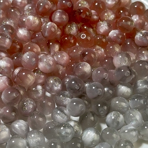 Macro detail of glossy resin beads with mermaid gradient effect and smooth finish