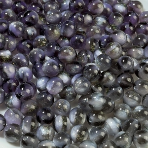 Macro view of 8-12mm purple shimmer resin beads with galaxy sparkle for DIY jewelry
