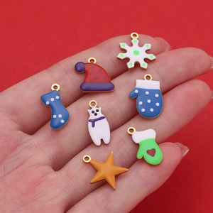 Detailed set of Christmas charms with colorful enamel motifs on a vibrant red background
