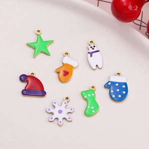 Detail of Christmas enamel charms including stars and mittens for jewelry making