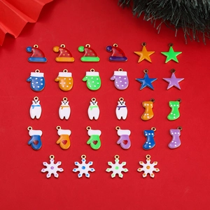 Flat lay of colorful enamel Christmas charms including stars and hats for DIY jewelry