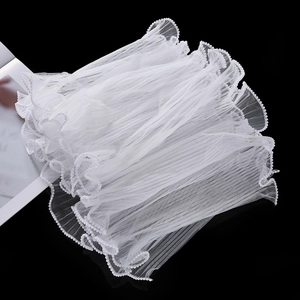 Close-up of white wavy pleated mesh with pearl trim for floral wrapping and DIY crafts