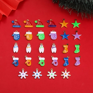 Colorful enamel Christmas charms in various shapes on a festive red background