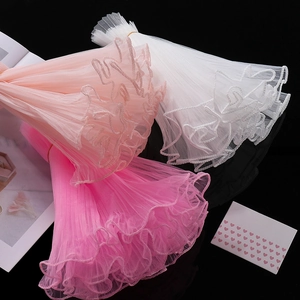 Detail of wavy organza lace trimming in white, light pink and rose red for DIY crafts