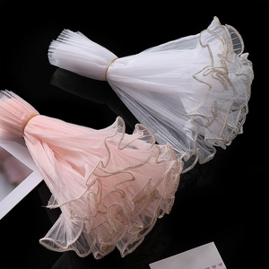 Detail of wavy organza ribbon with pearl edges in white and pink for DIY floral packaging