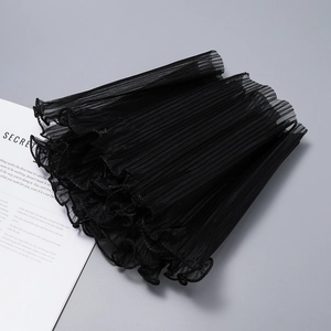 Macro shot of black pleated chiffon fabric with ruffled edges for flower bouquet decor