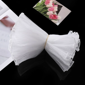 Detail of white pleated mesh ribbon with pearl edge for DIY flower bouquet wrapping