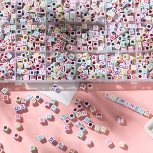 Close-up of 6x6mm colorful acrylic letter cube beads and organized storage box