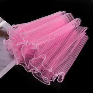 Detail of pink wavy tulle mesh with white pearl edge trim for floral and DIY gift wrapping