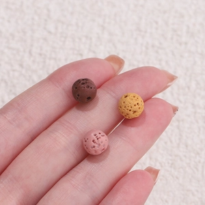 Macro shot of brown, yellow, and pink porous lava stone beads for aromatherapy jewelry