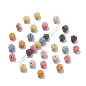 Macro detail of multicolored lava stone beads with porous texture for DIY jewelry making