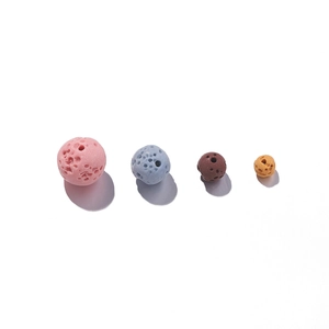 Macro detail of colorful porous lava stone beads for essential oil jewelry making