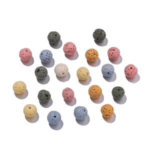Macro detail of colorful porous volcanic stone beads for DIY essential oil jewelry making