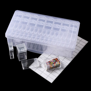 Detail view of 28-grid clear plastic storage box with independent lids and labeling stickers