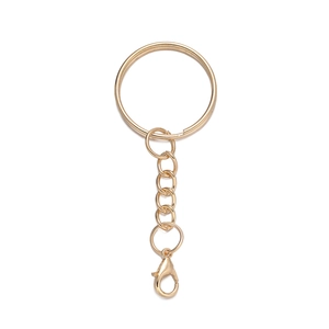Detailed close-up of golden metal keyring with chain and lobster clasp for DIY accessories