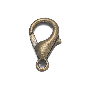 Close-up of bronze-finish metal lobster clasp and spring hook for DIY jewelry making