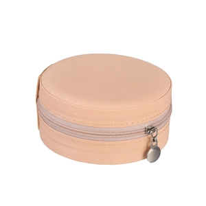 Macro view of round pink Saffiano leather jewelry box with a metal zipper closure