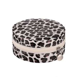 Top view of round jewelry storage box with leopard print and silver metal zipper