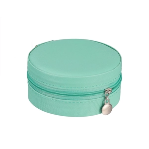 Detail of round mint green fabric jewelry box with silver zipper and textured finish