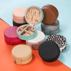 Multi-color round portable jewelry organizers showing interior storage and ring slots