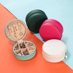Detailed interior of portable round jewelry case with hooks and ring slots in various colors