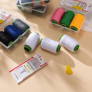 Close-up of portable sewing kit with 16 steel needles, threader, and 7 color threads