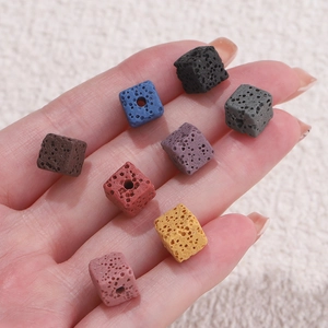 Macro shot of colorful cubic volcanic lava beads with natural porous texture for DIY jewelry