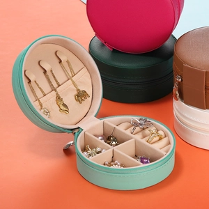 Portable round jewelry storage box with ring slots and necklace hooks in various colors