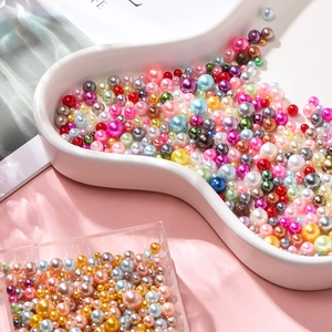 Colorful mixed size faux pearl beads in a decorative cloud tray for DIY crafts