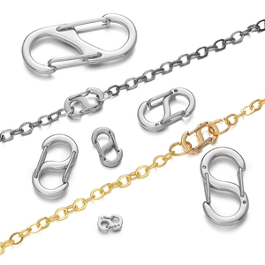 Macro detail of various sized gold and silver S-shaped jewelry connectors on delicate chains