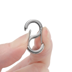 Macro shot of a small stainless steel S-shaped connector clasp for DIY jewelry making
