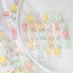 Close-up of 26 colorful 3D bubble resin alphabet beads in macaron tones for DIY crafts