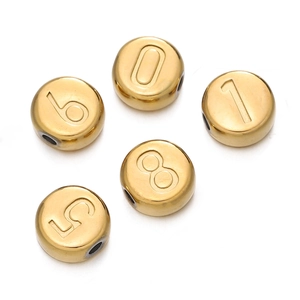 Detailed macro view of gold-plated 7mm stainless steel numeric beads for DIY jewelry