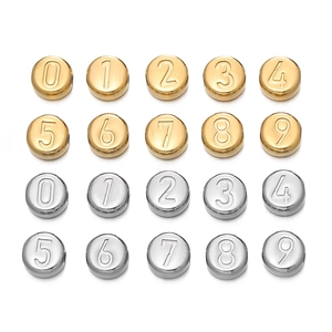 Macro shot of stainless steel numbered round beads in gold and silver for DIY jewelry