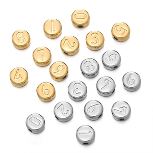 Close-up of 7mm vacuum plated stainless steel number beads in gold and silver for DIY jewelry