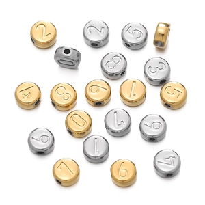 Detailed macro view of 7mm gold and silver vacuum plated stainless steel number beads