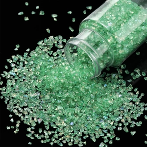 Macro detail of iridescent light green glass shards falling from a 30g plastic bottle