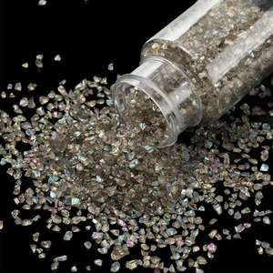 Macro detail of iridescent colorful glass gravel and crystal sand for DIY nail art crafts