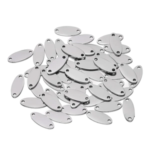 Macro shot of polished oval stainless steel tags with dual-hole design for DIY jewelry