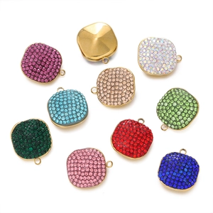 Detailed overhead view of assorted colorful square crystal pendants for DIY jewelry crafting
