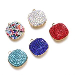 Close-up of five colorful square crystal pendants with stainless steel loops for DIY jewelry